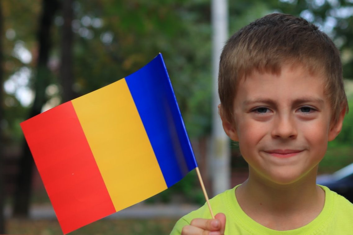 Young Kid holding Romania and Greece flags edited 2